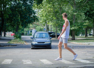 a pedestrian crossing the street in Alpharetta, GA