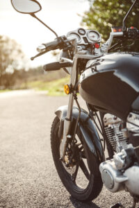 Black shiny motorcycle on road over a nature background