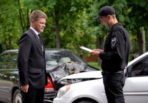 man filling out a police report after a car accident